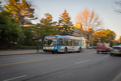 A slow shutter speed picture of a city bus.